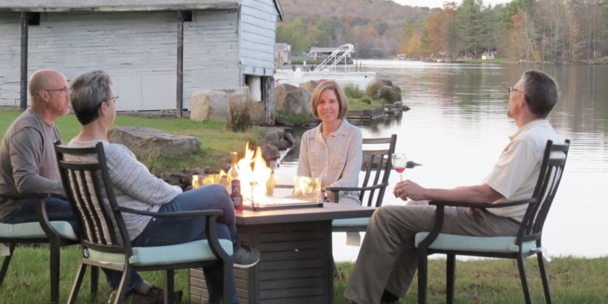 Friends enjoying a gas fire table