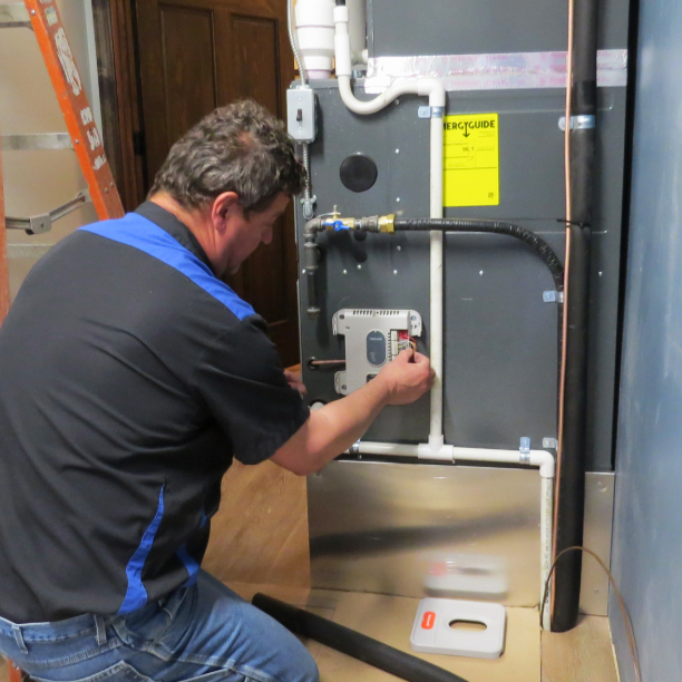 SBG HVAC technician working on Amana furnace