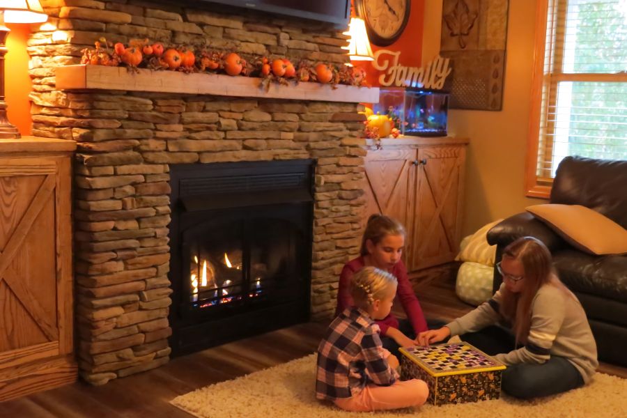 Children playing checkers around White Mountain Hearth Vail 32 Vent Free Fireplace